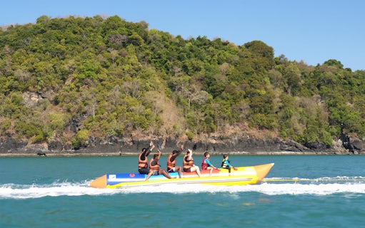Banana boat ride near Intan Kecil Island, Langkawi, with lush greenery in the background.