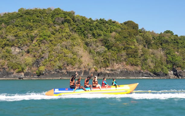 Banana boat ride near Intan Kecil Island, Langkawi, with lush greenery in the background.