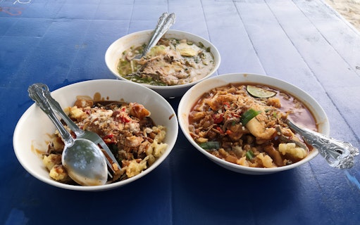 Bowls of traditional Malaysian dishes on a table during Langkawi Makan Makan Food Tour by Jet Ski.
