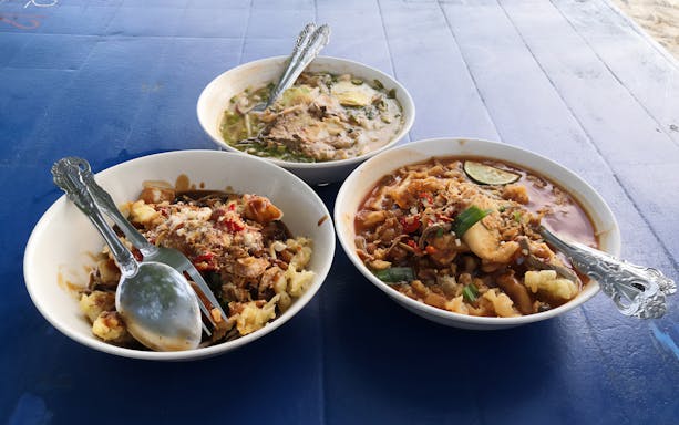 Bowls of traditional Malaysian dishes on a table during Langkawi Makan Makan Food Tour by Jet Ski.