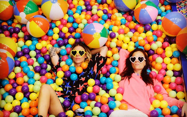 Visitors enjoying colorful ball pit at Selfie Museum Firenze.
