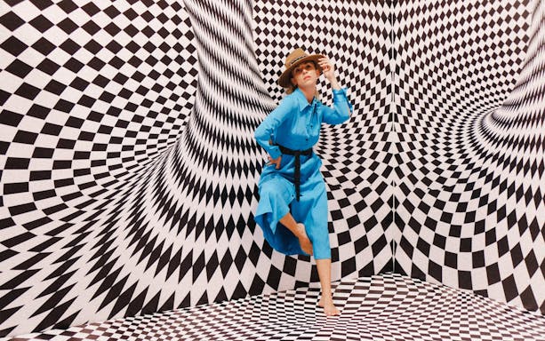 Person posing in optical illusion room at Selfie Museum Firenze.