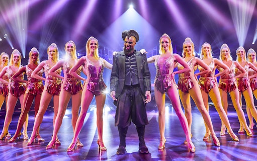 Performer and dancers on stage at ARISE Grand Show, Berlin.