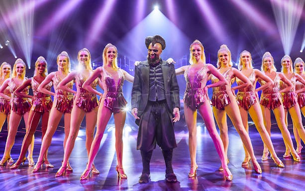 Performer and dancers on stage at ARISE Grand Show, Berlin.