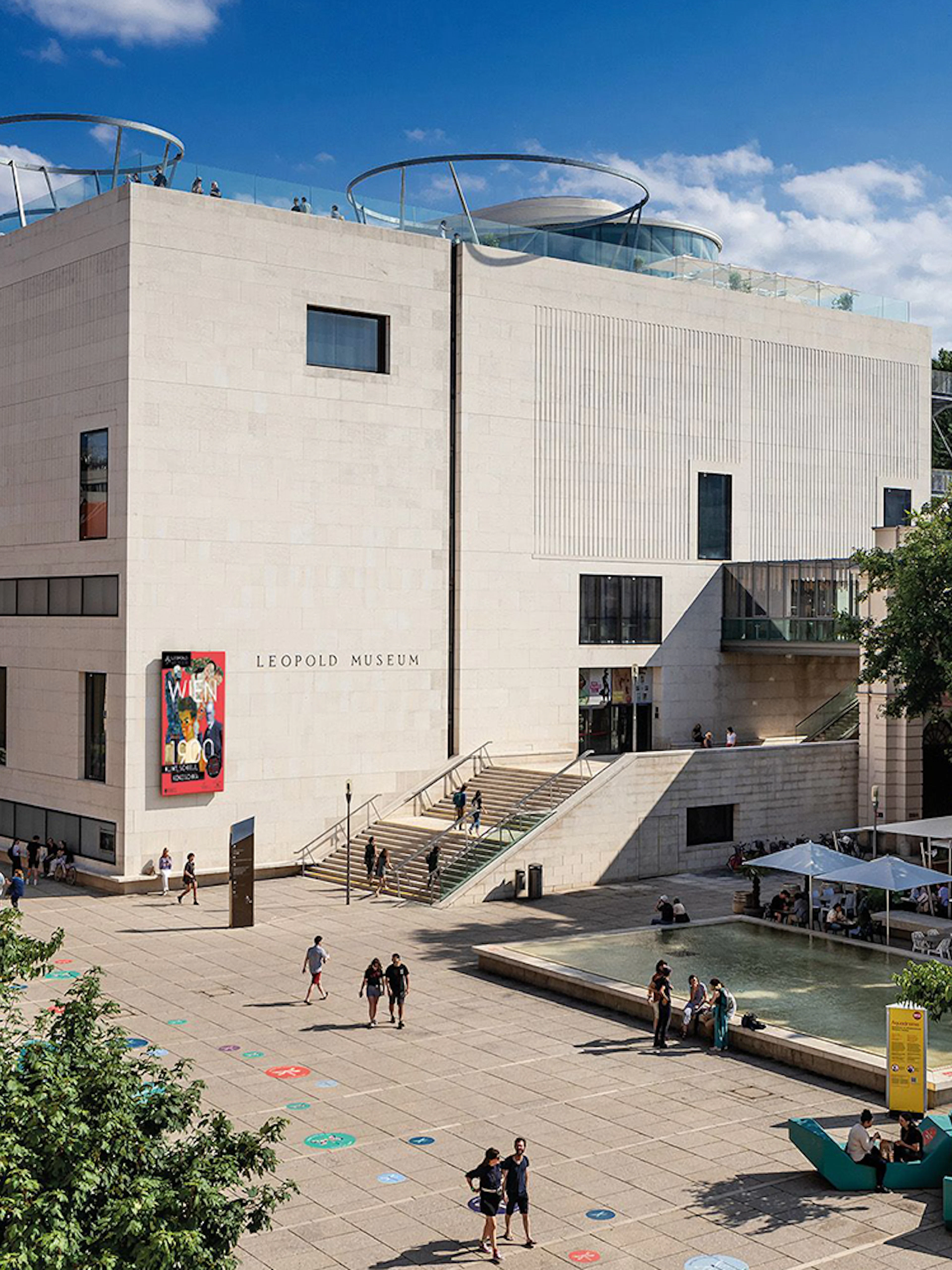 Tourists with tickets exploring the Leopold Museum courtyard in Vienna.