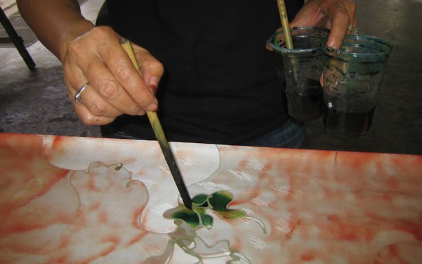 Batik painting demonstration during Kuala Lumpur Countryside Exploration and Batu Caves Tour.