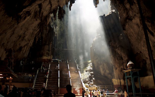 Batu Caves interior with sunlight streaming through, Kuala Lumpur tour.