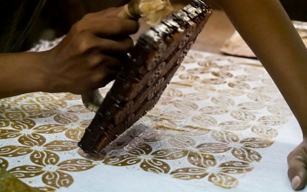 Batik printing demonstration during Kuala Lumpur Countryside Exploration and Batu Caves Tour.