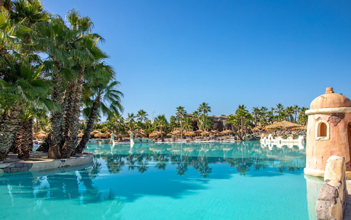 Caribe Bay water park with palm trees and lagoon, Italy.