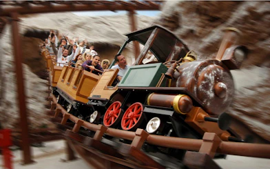 Train model ride with passengers at Gardaland Park.