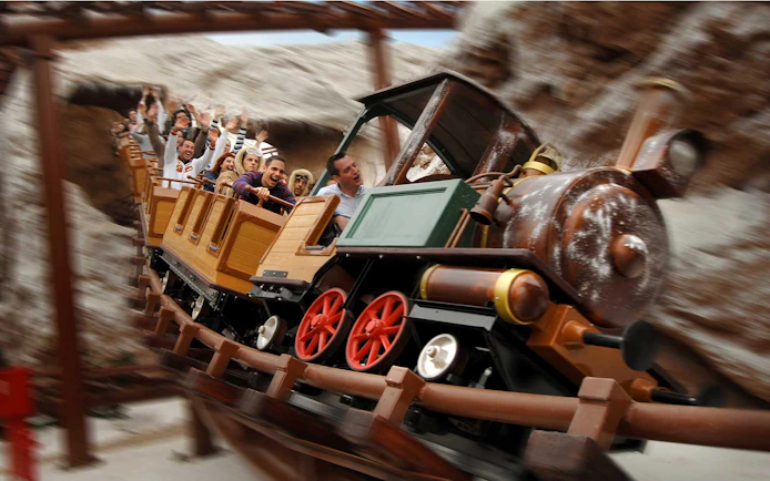 Train model ride with passengers at Gardaland Park.