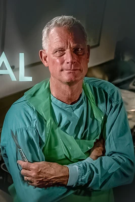 Dr Richard Shepherd in surgical attire promoting "Unnatural Causes" theatre tour.