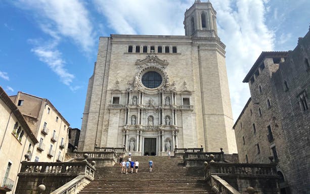 Girona Cathedral with tourists climbing the steps, Spain.
