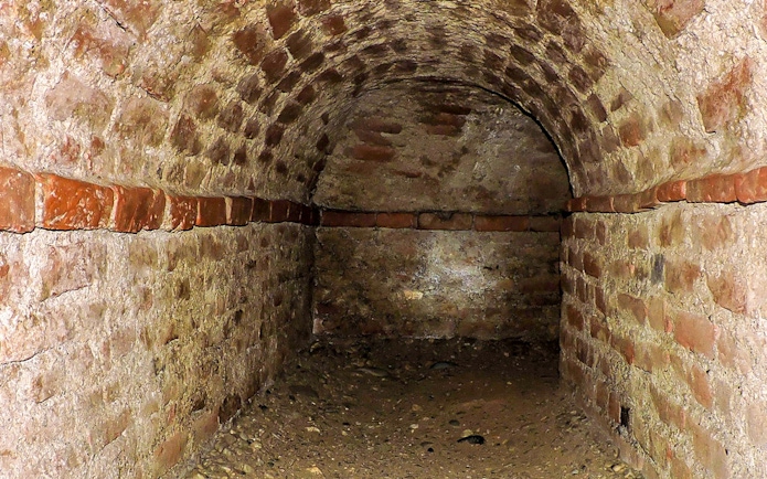 Brick tunnel in the Turin underground, part of a guided walking tour.