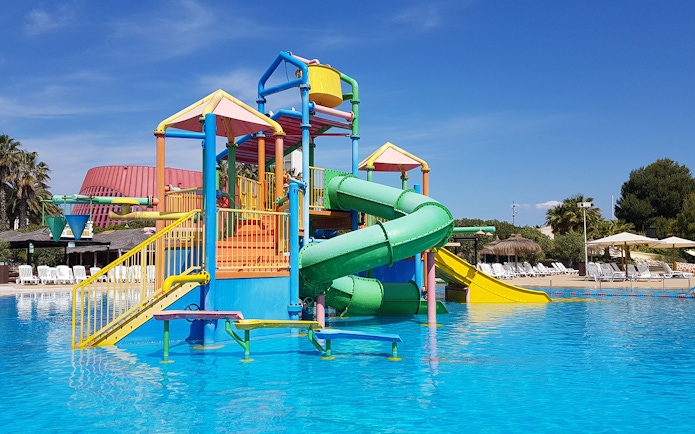 Colorful water play structure with slides at Aquopolis Costa Daurada.