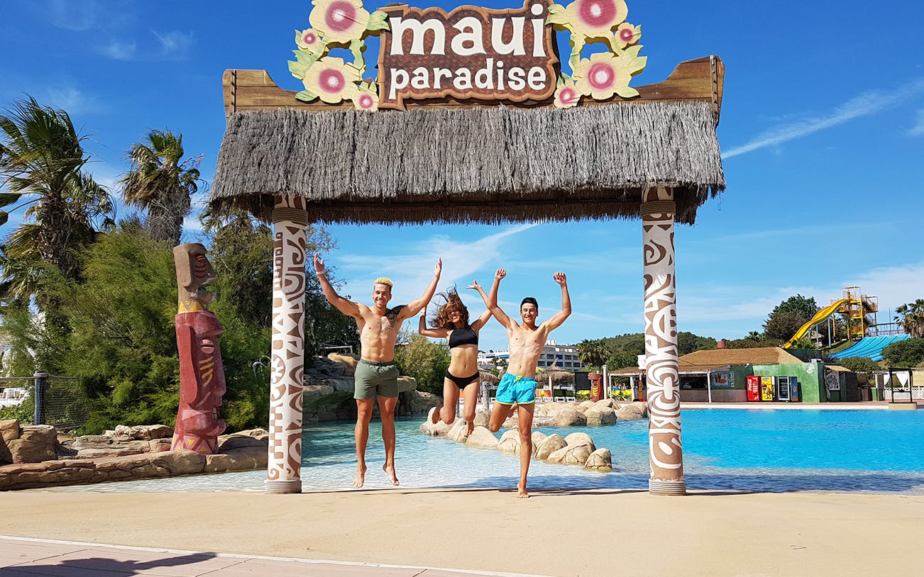 Visitors jumping at Maui Paradise entrance, Aquopolis Costa Daurada.