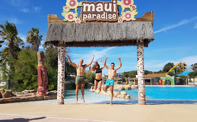 Visitors jumping at Maui Paradise entrance, Aquopolis Costa Daurada.