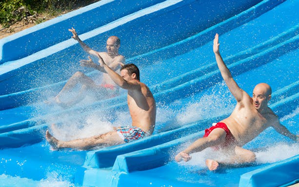 Visitors enjoying water slides at Aquopolis Cullera.