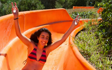 Person enjoying a water slide at Aquopolis Cullera.