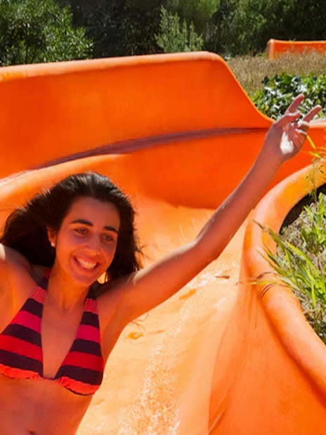 Person enjoying a water slide at Aquopolis Cullera.
