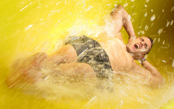 Person sliding down a water slide at Aquopolis Torrevieja.