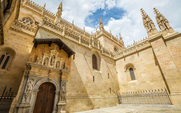 Granada Cathedral facade with intricate carvings, part of the guided tour including Alhambra and Royal Chapel.