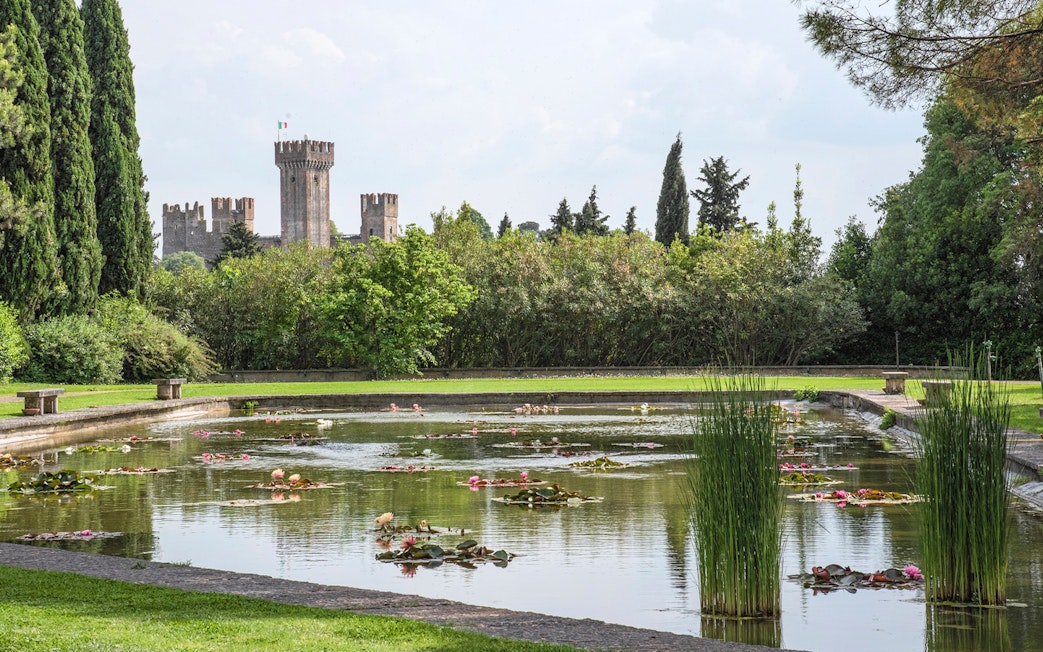 Lily pond with castle view at Parco Giardino Sigurtà, Italy.