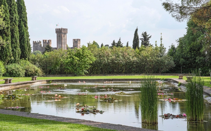 Lily pond with castle view at Parco Giardino Sigurtà, Italy.
