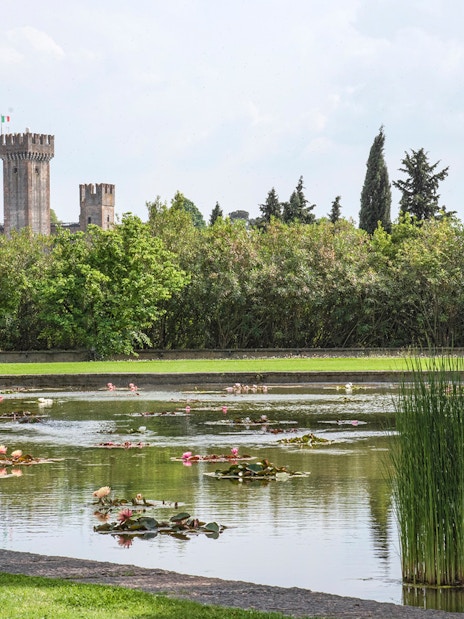 Lily pond with castle view at Parco Giardino Sigurtà, Italy.