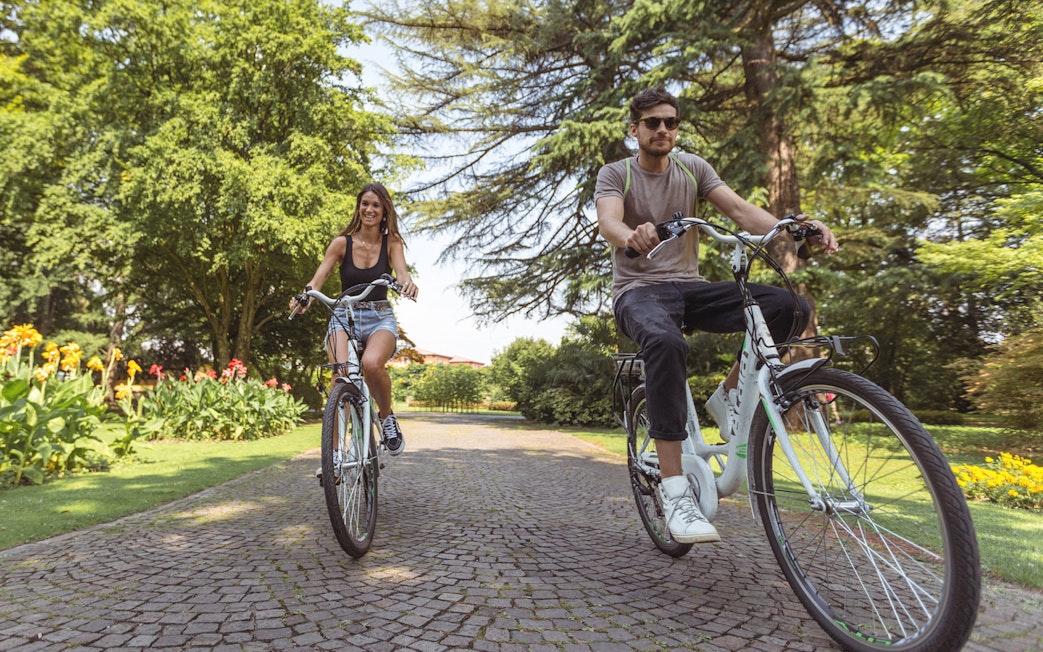Cyclists enjoying a ride through Parco Giardino Sigurtà's scenic paths.