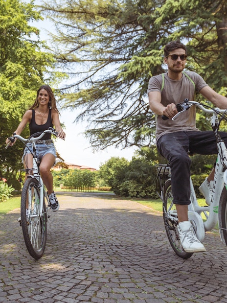 Cyclists enjoying a ride through Parco Giardino Sigurtà's scenic paths.