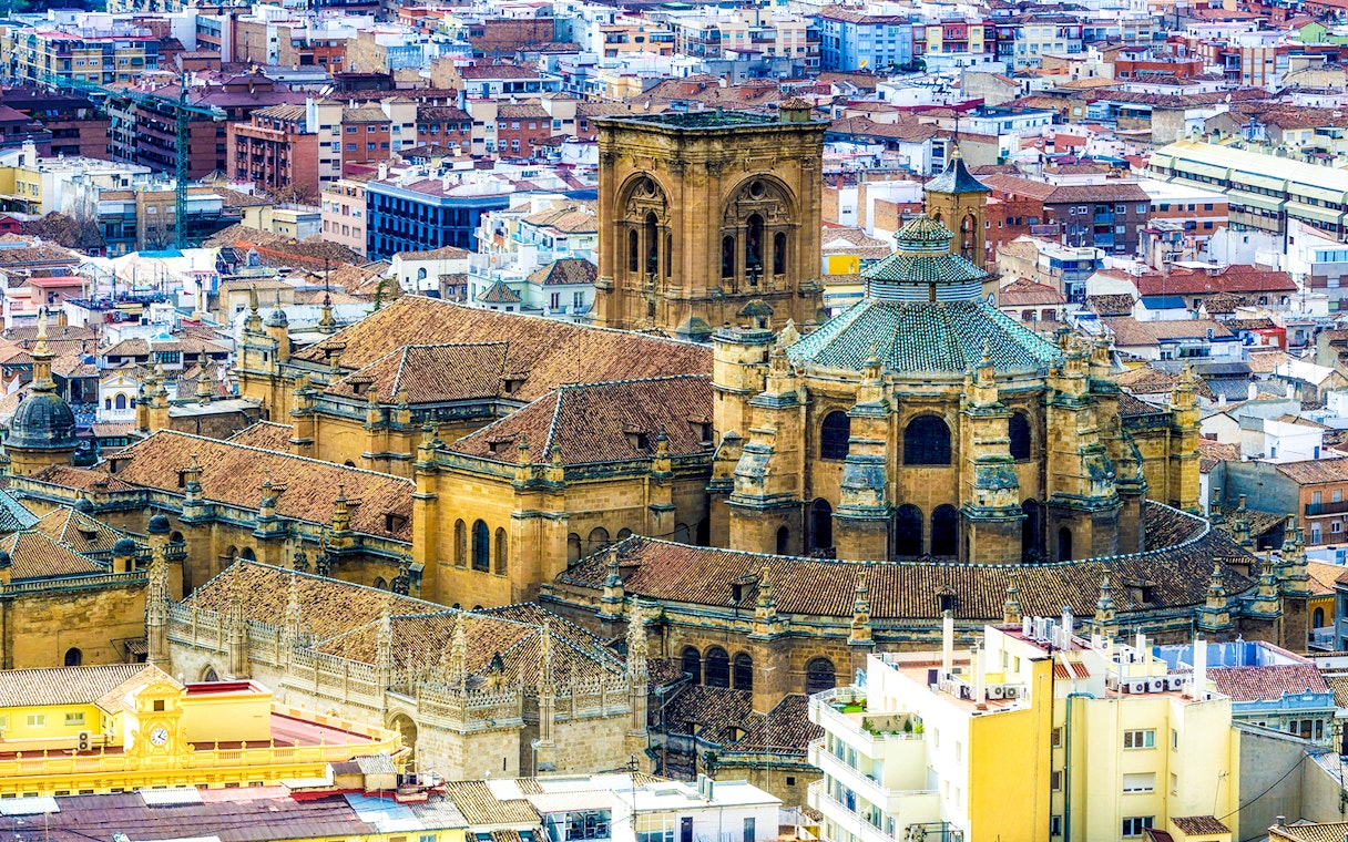 Cathedral and Royal Chapel of Granada with cityscape in the background.