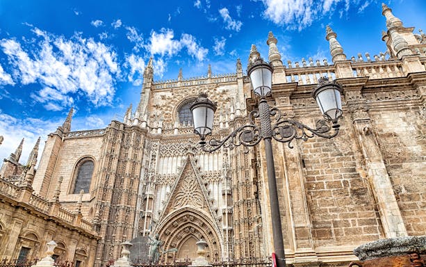 Cathedral and Royal Chapel of Granada facade with ornate Gothic architecture.