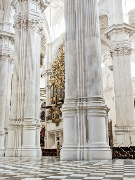 Interior of Cathedral and Royal Chapel of Granada with ornate columns and arches.