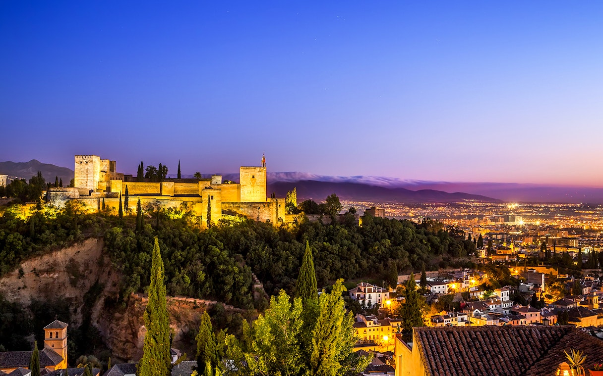 Alhambra Palace overlooking Granada at sunset, near Cathedral and Royal Chapel of Granada.