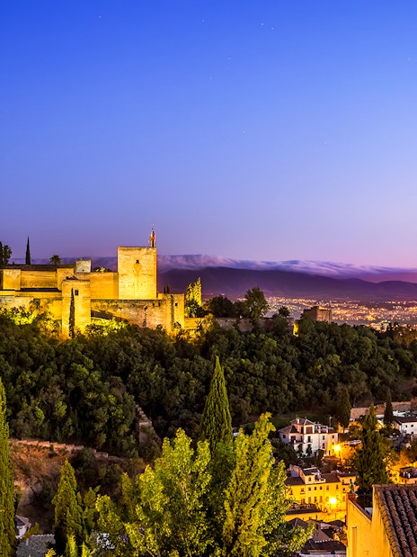 Alhambra Palace overlooking Granada at sunset, near Cathedral and Royal Chapel of Granada.