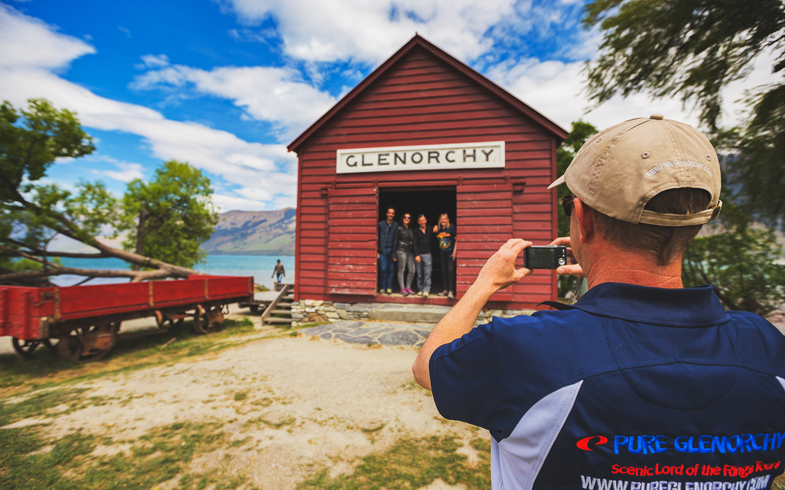 Glenorchy red shed with tourists, part of Lord of the Rings tour from Queenstown.
