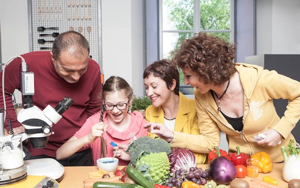 Visitors engaging in a science experiment with vegetables at the National Museum of Science and Technology Leonardo da Vinci.