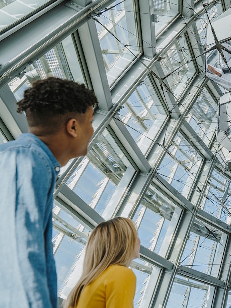 Visitors observing the geometric ceiling at Torre Glories Lookout.
