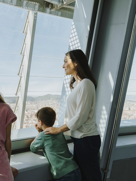 Family enjoying city view from Torre Glories Lookout in Barcelona.