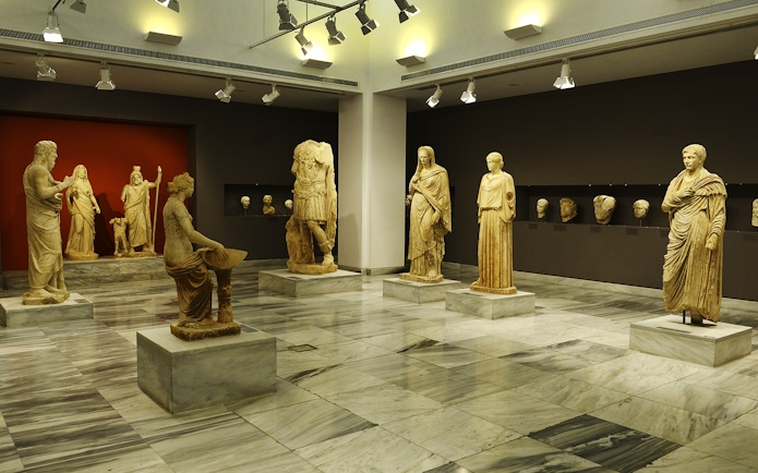 Statues displayed in Heraklion Archaeological Museum exhibit hall.