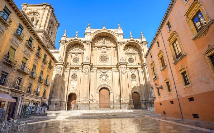 Granada Cathedral facade with surrounding historic buildings in Albaicin, Spain.
