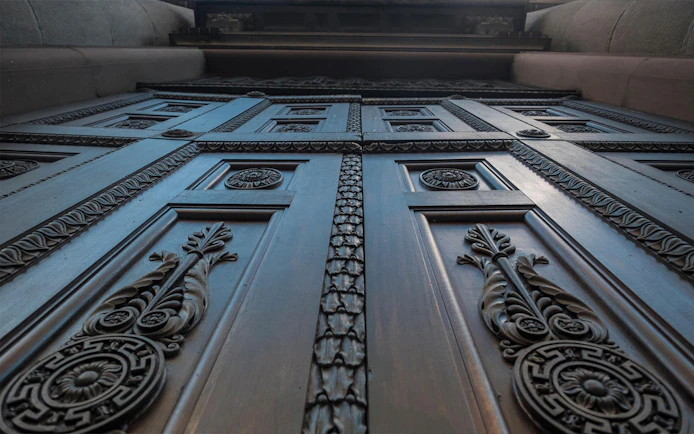Ornate wooden door detail on the Italian Guided Tour through Torino Noir.
