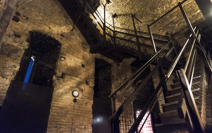 Staircase inside historic brick building on Italian Guided Tour through Torino Noir.