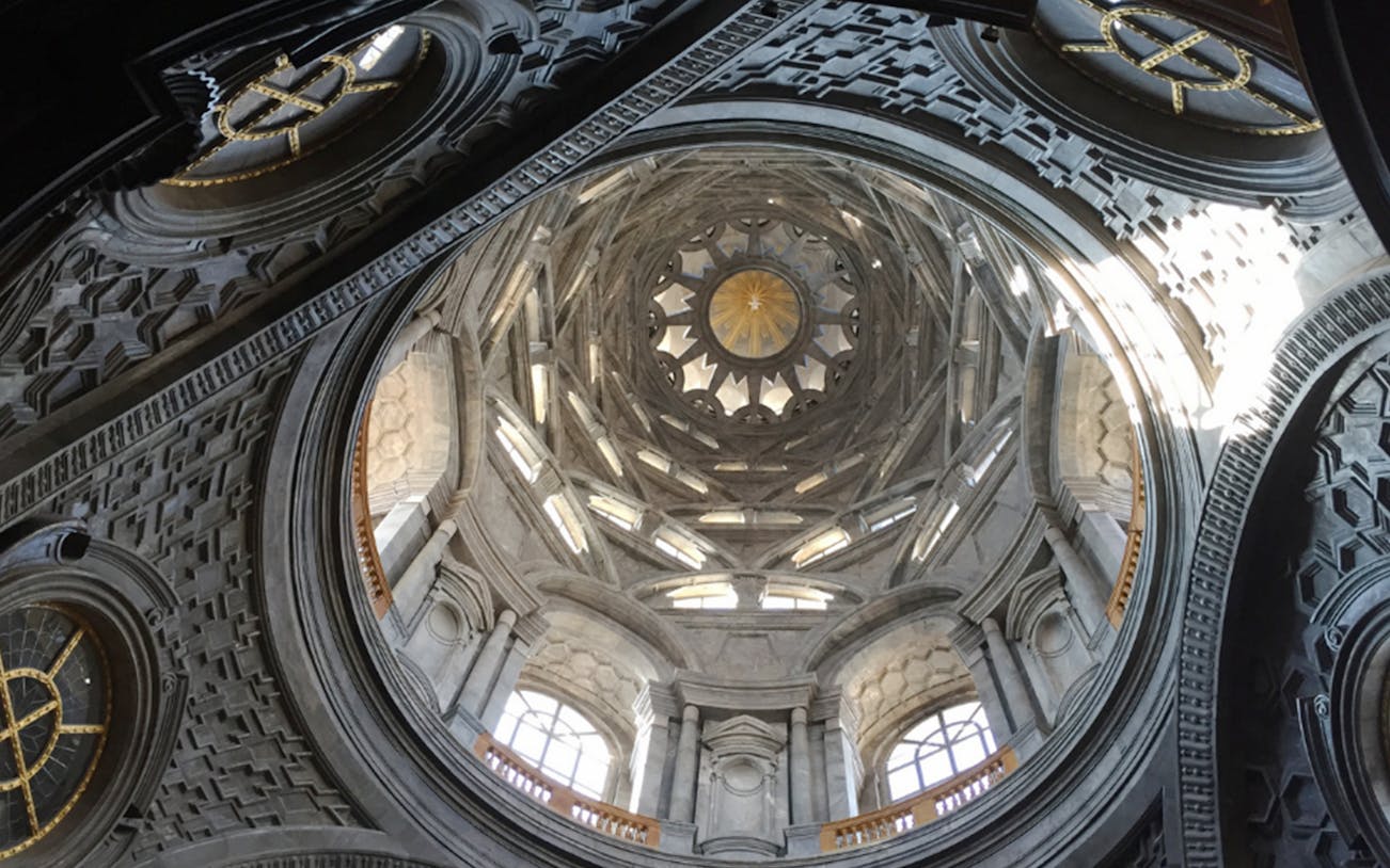 Interior view of the Royal Palace of Turin dome with intricate architectural details.