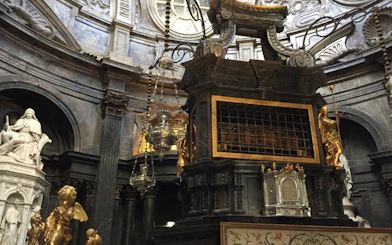 Interior of the Royal Palace of Turin with ornate sculptures and intricate architectural details.