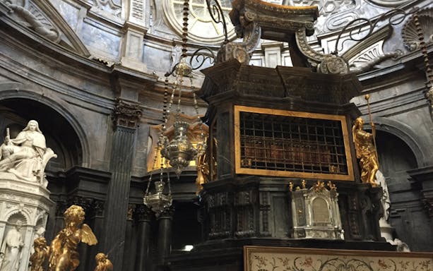 Interior of the Royal Palace of Turin with ornate sculptures and intricate architectural details.