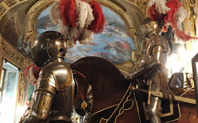 Armored knights on horseback inside the Royal Palace of Turin.