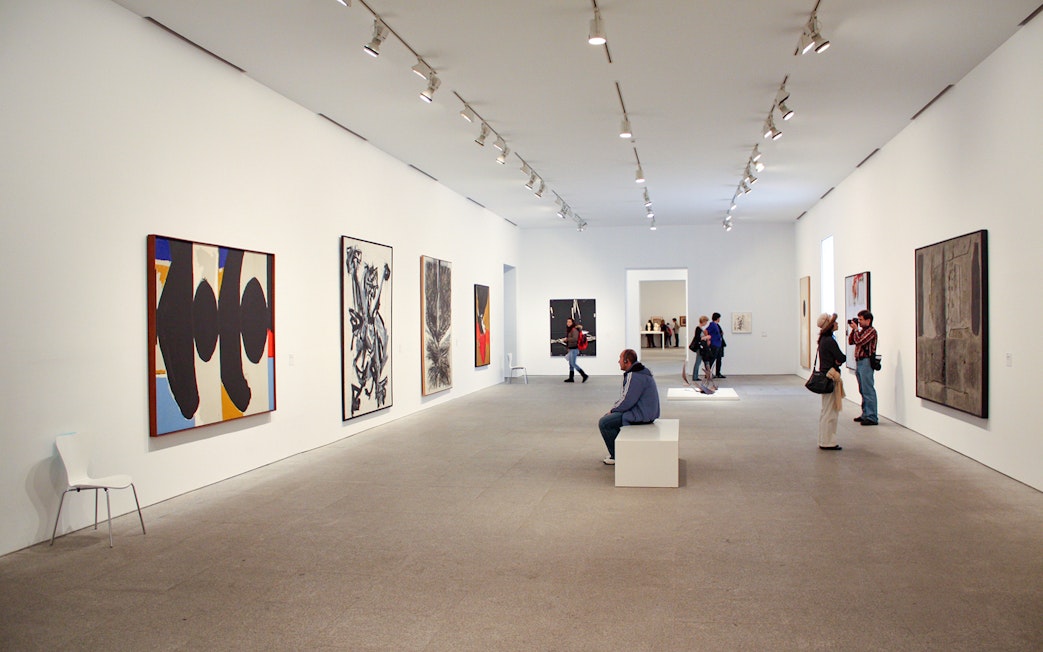 Visitors viewing modern art at Reina Sofia Museum, Madrid.