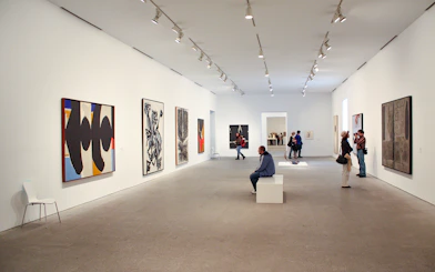 Visitors viewing modern art at Reina Sofia Museum, Madrid.